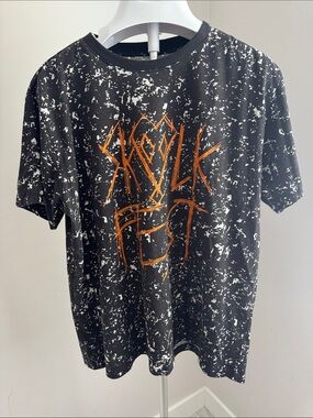 Original Use Black Tee with White Splatter and Orange Accent